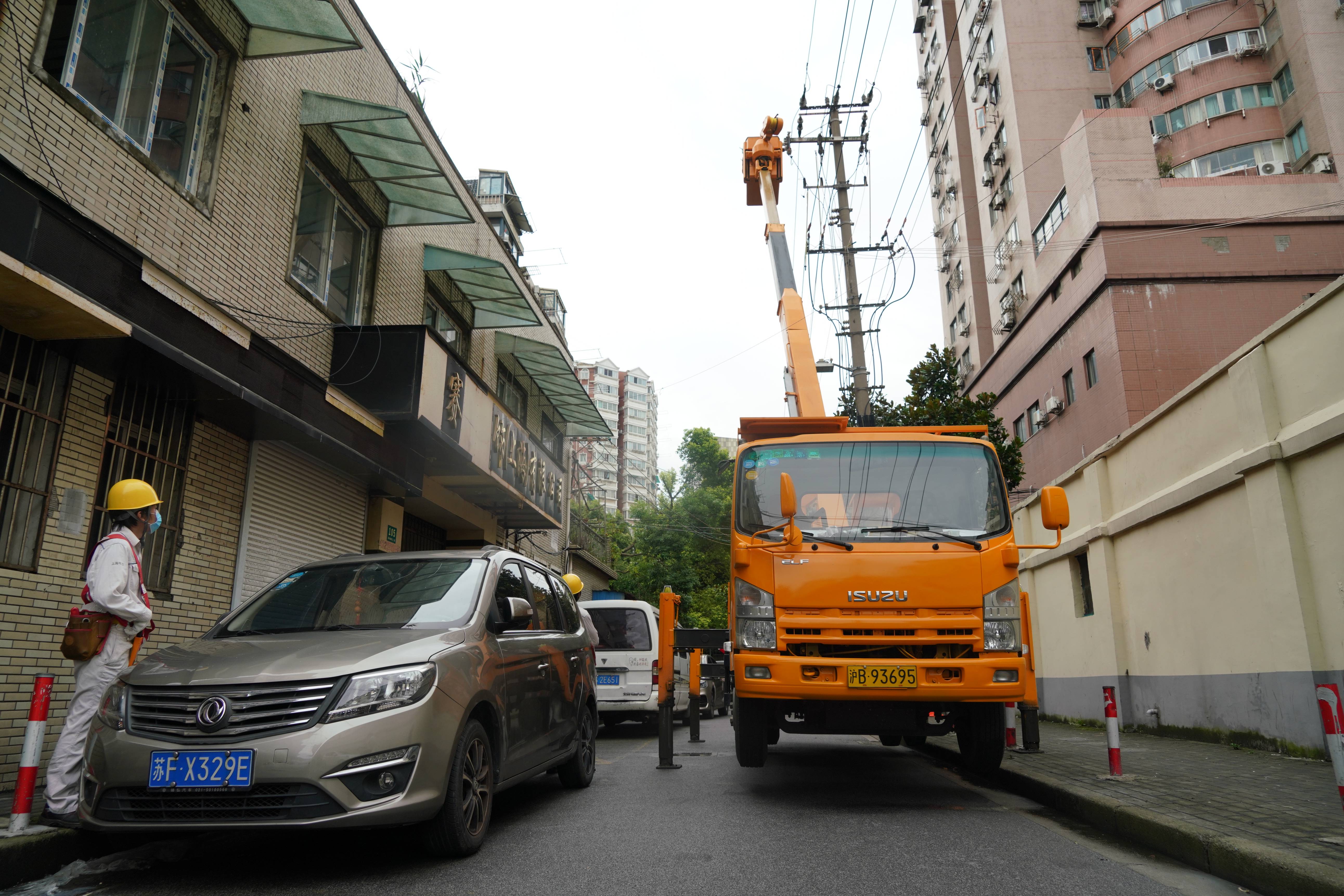 8月5日上午，国网上海电力工作人员在杨浦区眉州路，用带电作业方式调换受损的高压消弧熔丝。国网上海市电力公司供图