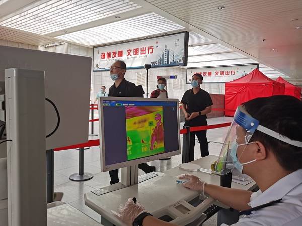 上海站工作人员为进、出站旅客测温 王程伟 摄.jpg